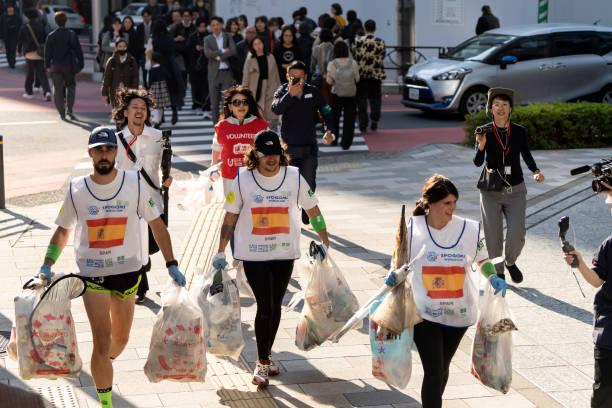 Members of the Spain team carry plastic bags containing rubbish during the final stage of the SPOGOMI World Cup 2023 in Tokyo