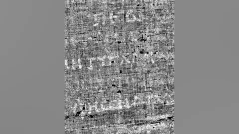 Vesuvius Challenge Close up view of a black and white image of an unrolled scroll from Herculaneum made by x-ray scans and AI. Some Greek letters are visible on the page - but words cannot yet be fully made out.  