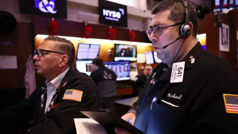 Getty Images Two stock market traders in the US look at computer screens