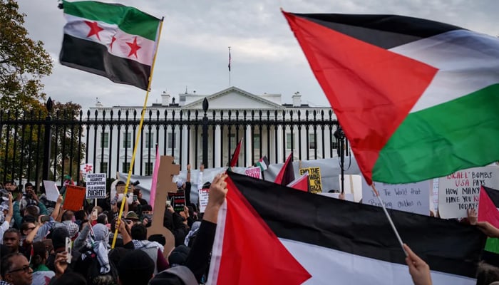 Demonstrators fly Palestinian flags outside the White House in the US during the National March on Washington for Palestine while calling for a ceasefire between Israel and Hamas on November 4, 2023. — AFP