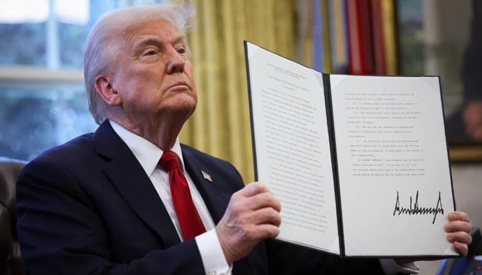 Donald Trump signs an executive order to introduce sweeping changes to US electoral process. — AFP