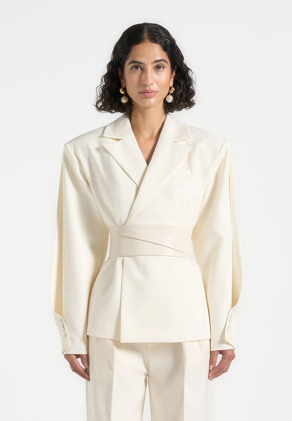 Model wears cream broad shoulder blazer